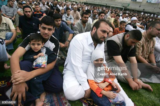 Muslims listen to the Palestinian dismissed prime minister and Hamas leader Ismail Haniyeh give a speech during a mass prayer on the first day of the...