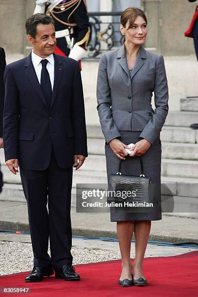 French president Nicolas Sarkozy and his wife Carla Bruni-Sarkozy greet Pope Benedict XVI as he leaves the courtyard of the Elysee Palace on...