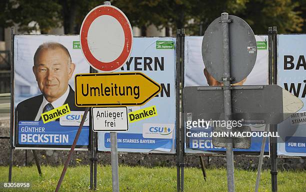 Detour" sign stands in front of campaign posters featuring Bavarian Premier and CSU main candidate Guenther Beckstein in Munich on September 30,...