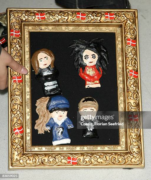 Picture of the Band Tokio Hotel is shown by a fan during the Bill Kaulitz wax figure presentation at Madame Tussauds on September 30, 2008 in Berlin,...
