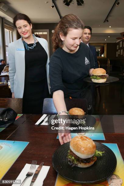 Wellington Central candidate Nicola Willis and MP Simon Bridges look on as the 'Bill English Burger' is served at The Backbencher gastropub on August...