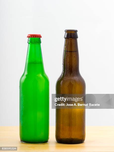 bottles of  beer with the glass esmerilado with drops of water and a steam cloud frozen on a white bottom - beer mat stockfoto's en -beelden