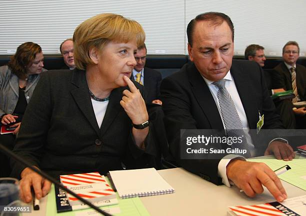 German Chancellor Angela Merkel and Axel Weber, head of the German central bank, the Bundesbank, sit down for a meeting of the German Christian...