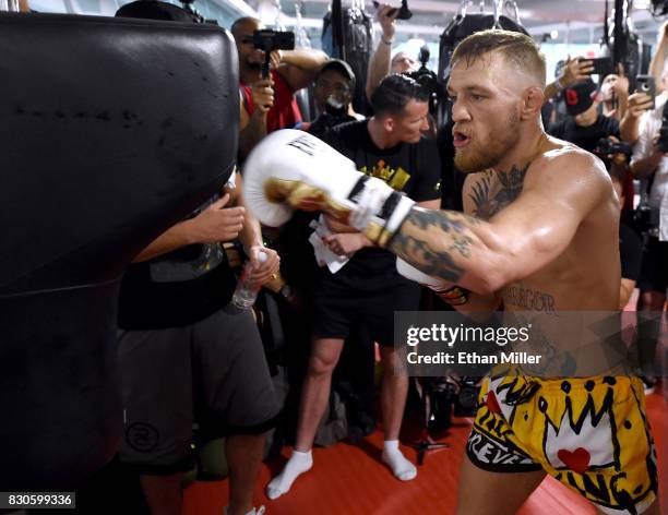 Lightweight champion Conor McGregor hits an uppercut bag during a media workout at the UFC Performance Institute on August 11, 2017 in Las Vegas,...