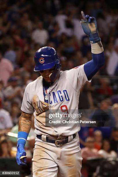 Javier Baez of the Chicago Cubs reacts after sliding into home plate to score a run against the Arizona Diamondbacks during the eighth inning of the...