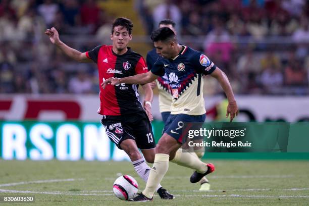 Javier Salas of Atlas fights for the ball with Silvio Romero of America during the 4th round match between Atlas and America as part of the Torneo...