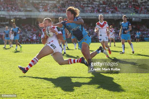 Jason Nightingale of the Dragons scores a try under pressure from Kevin Proctor of the Titans during the round 23 NRL match between the St George...