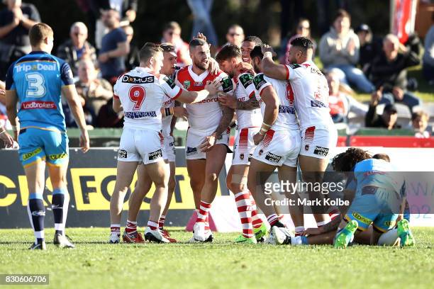 Joel Thompson of the Dragons celebrates with his team mates after scoring a try during the round 23 NRL match between the St George Illawarra Dragons...