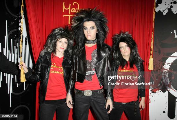 Fans pose with Tokio Hotel's Bill Kaulitz wax figure during its unveiling at Madame Tussauds on September 30, 2008 in Berlin, Germany.