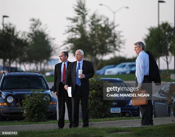 Republican presidential nominee, Arizona Senator John McCain, and advisor Rob Portman make their way to an interview September 30, 2008 in West Des...