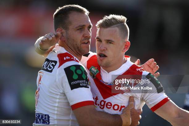 Jason Nightingale of the Dragons celebrates with his team mate Matthew Dufty of the Dragons after scoring a try during the round 23 NRL match between...