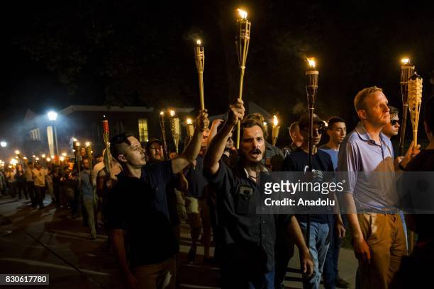 Neo Nazis, Alt-Right, and White Supremacists march through the University of Virginia Campus with torches in Charlottesville, Va., USA on August 11,...