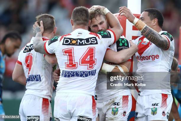 The Dragons celebrate a try scored by Kurt Mann of the Dragons during the round 23 NRL match between the St George Illawarra Dragons and the Gold...