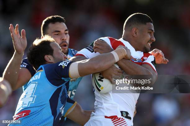 Ryan James and Tyrone Roberts of the Titans tackle Nene MacDonald of the Dragons during the round 23 NRL match between the St George Illawarra...