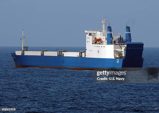 In this handout image provided by the U.S. Navy, the MV Faina, one of the three pirated cargo vessels, is observed by the guided-missile cruiser USS...