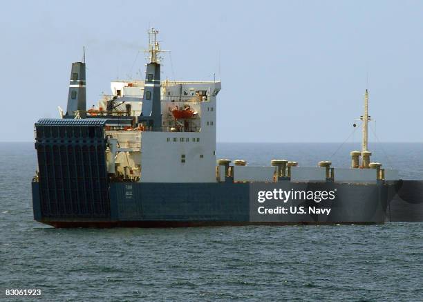 In this handout image provided by the U.S. Navy, the MV Faina, one of the three pirated cargo vessels, is observed by the guided-missile cruiser USS...