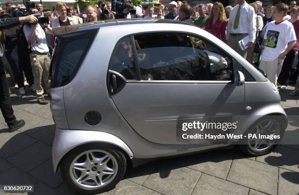 Fourteen people cram themselves in a Smart car, one of the smallest production cars on the market, in the centre of Nottingham, to break a world...