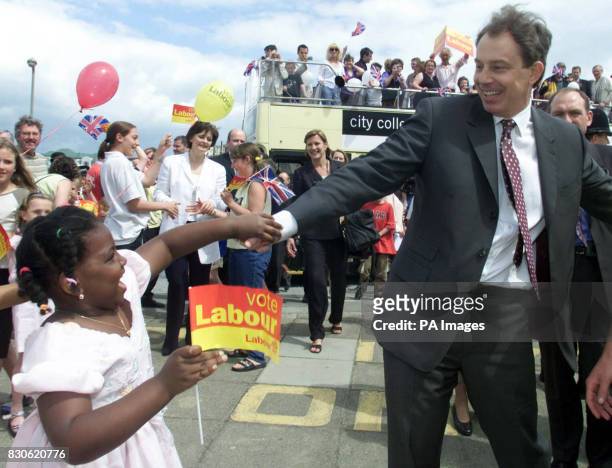 Britain's Prime Minister Tony Blair greets well-wishers as he visits Saltdean Community Club, Brighton, East Sussex. Mr Blair used a bus to undertake...