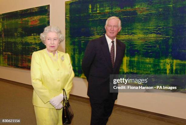 Britain's Queen Elizabeth II and the owner of the Astrup Fearnley Museum, Thomas Fearnley, pass some works by Gerhard Richter at the Museum in Oslo,...