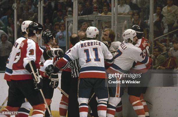 Officials break up a fight between members of the New York Islanders and the Philadelphia Flyers during a game in the Stanley Cup finals, held...