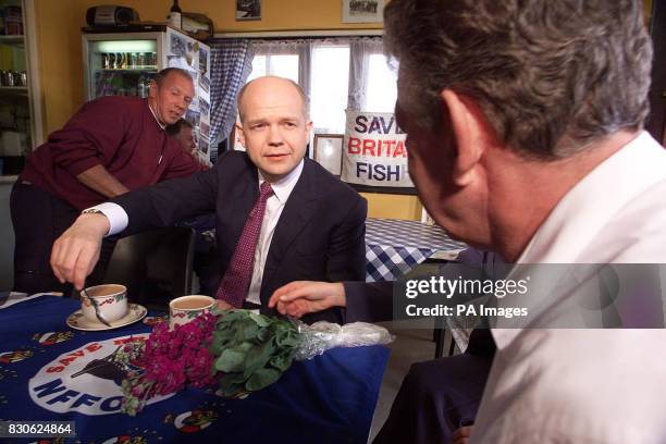 Conservative Party leader William Hague talks to fishermen in Maggie's Cafe in Hastings' fish market while campaigning in the south coast town.