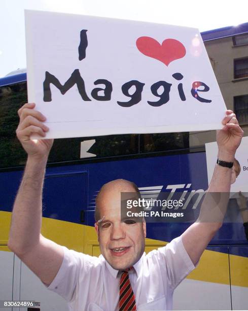 Demonstrator holds a placard and wears a WIlliam Hague mask as the Conservative Party leader and his wife, Ffion, campaign in Hastings. While meeting...