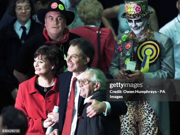 Prime Minister Tony Blair, with members of the Monster Raving Loony Party behind him, gives his wife Cherie and father Leo, a hug after being...