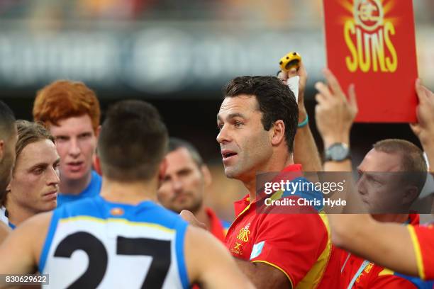 Suns interim Coach Dean Solomon talks to players during the round 21 AFL match between the Brisbane Lions and the Gold Coast Suns at The Gabba on...