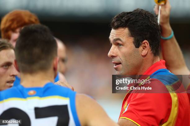 Suns interim Coach Dean Solomon talks to players during the round 21 AFL match between the Brisbane Lions and the Gold Coast Suns at The Gabba on...