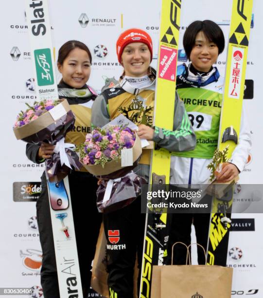 Germany's Katharina Althaus is flanked by Japan's Sara Takanashi and Yuki Ito after winning a summer Grand Prix ski jumping event in Courchevel,...