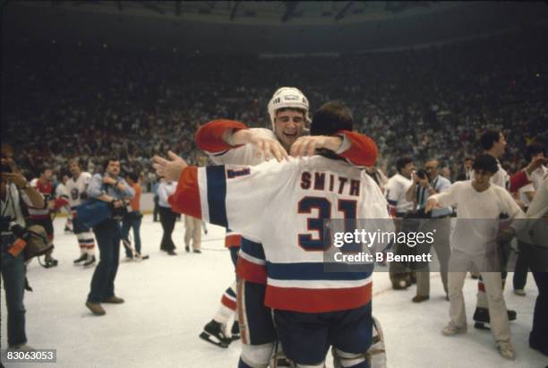 Canadian ice hockey player Billy Smith, goalkeeper for the New York Islanders, embraces teammate Duane Sutter as their team defeated the Philadelphia...