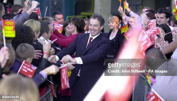 British Prime Minister Tony Blair with wife Cherie, is greeted by supporters as he arrives at the Labour Party headquarters at Millbank in central...