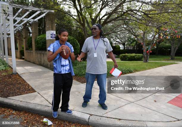 Clifton "Booney" McFowler, street intervention specialist with BUILD of Chicago in the Austin neighborhood, has a word with Latee Smith in the...