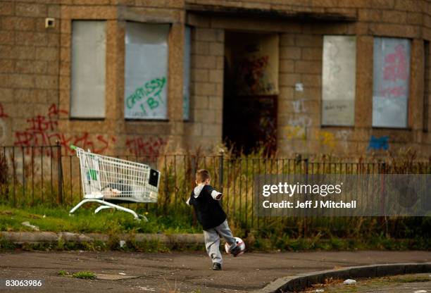 Two young boys play football in the street, September 30, 2008 in the Govan area of Glasgow, Scotland. A report by the Campaign to End Child Poverty...