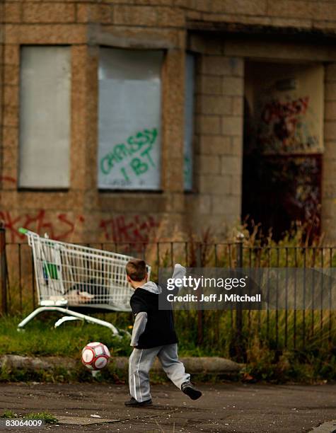 Two young boys play football in the street, September 30, 2008 in the Govan area of Glasgow, Scotland. A report by the Campaign to End Child Poverty...