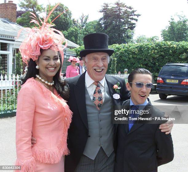Game show host Bruce Forsyth poses with his wife Wilnelia and jockey Frankie Dettori at the main entrance on Ladies Day - the fourth day of Royal...