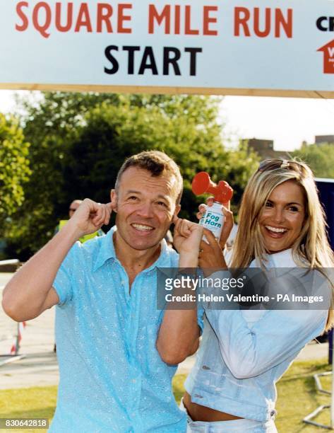 Comedian Graham Norton and television presenter Katy Hill, pose for the media during a photocall to start Crisis' Square Mile Run 2001, in . *... The...