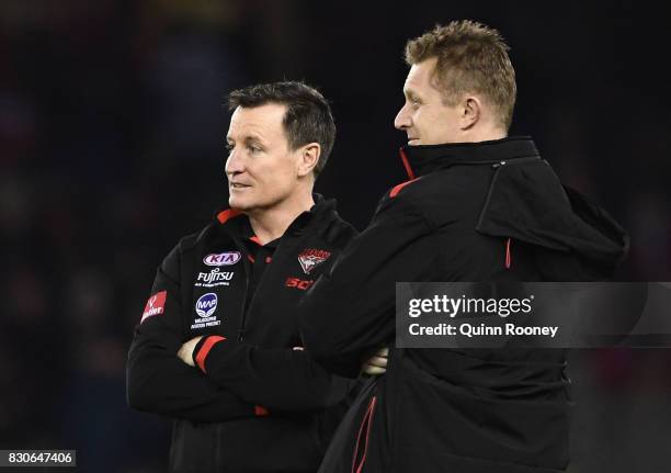 Bombers head coach John Worsfold talks to assistant Mark Neeld during the round 21 AFL match between the Essendon Bombers and the Adelaide Crows at...