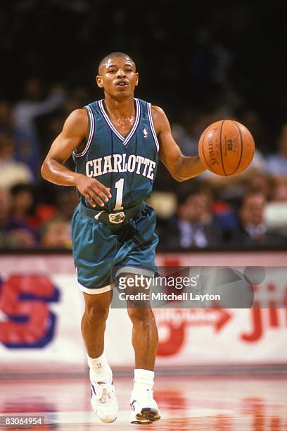 Tyrone Bogues of the Charlotte Hornets dribbles the ball up court during a NBA basketball game against the Washington Bullets at the U.S.Air Arena on...