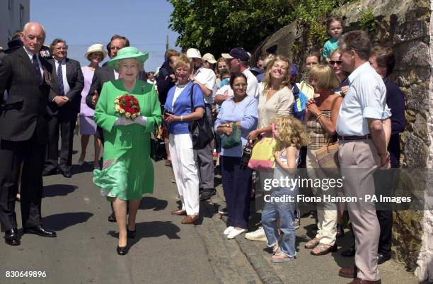 Britain's Queen Elizabeth II is welcomed by locals on arrival at the island of Alderney, on the first day of her two day visit to the Channel Islands.