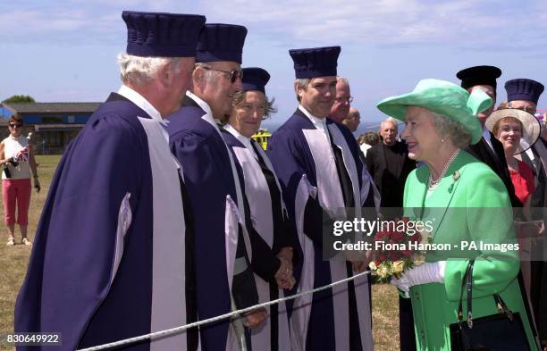 Britain's Queen Elizabeth II is greeted by members of local Goverment on the island of Alderney on the first day of her two day visit to the Channel...