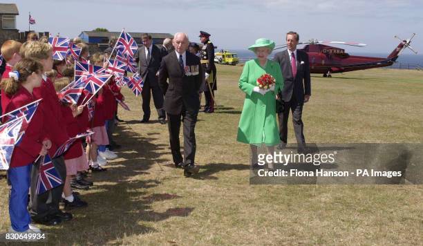 Britain's Queen Elizabeth II is greeted by school children as she arrives on the island of Alderney, on the first day of her two day visit to the...