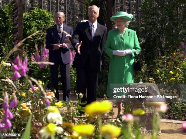 Britain's Queen Elizabeth II is accompanied around the Seigneurie gardens by the Seigneur, Michael Beaumont , on the island of Sark, at the start of...