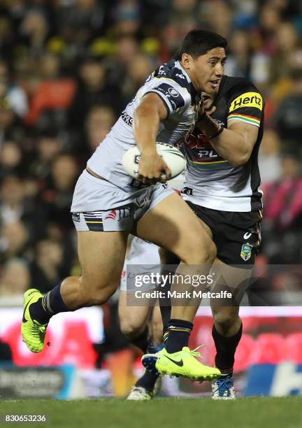 Jason Taumalolo of the Cowboys breaks through tackles during the round 23 NRL match between the Penrith Panthers and the North Queensland Cowboys at...