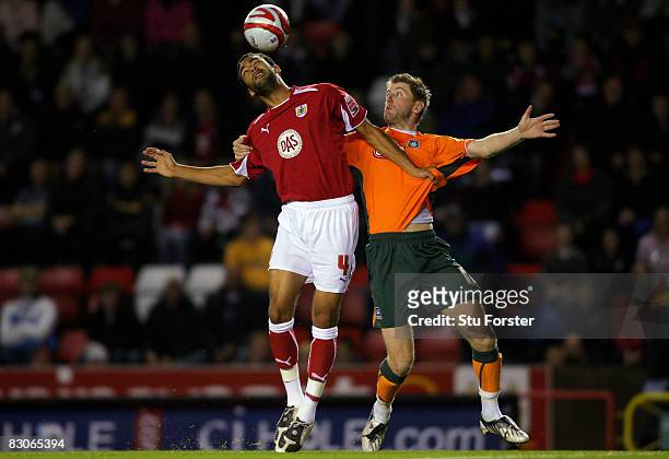 Plymouth striker Paul Gallagher battles with Bristol City defender Liam Fontaine during the Coca Cola Championship game between Bristol City and...