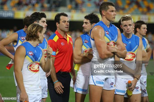 Suns interim Coach Dean Solomon and Suns look on after losing the round 21 AFL match between the Brisbane Lions and the Gold Coast Suns at The Gabba...