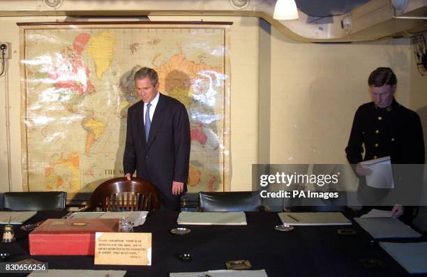 President George W. Bush inspects the seat of Winston Churchill in the Cabinet War Rooms in London. The former The World War II leader's bunker is...