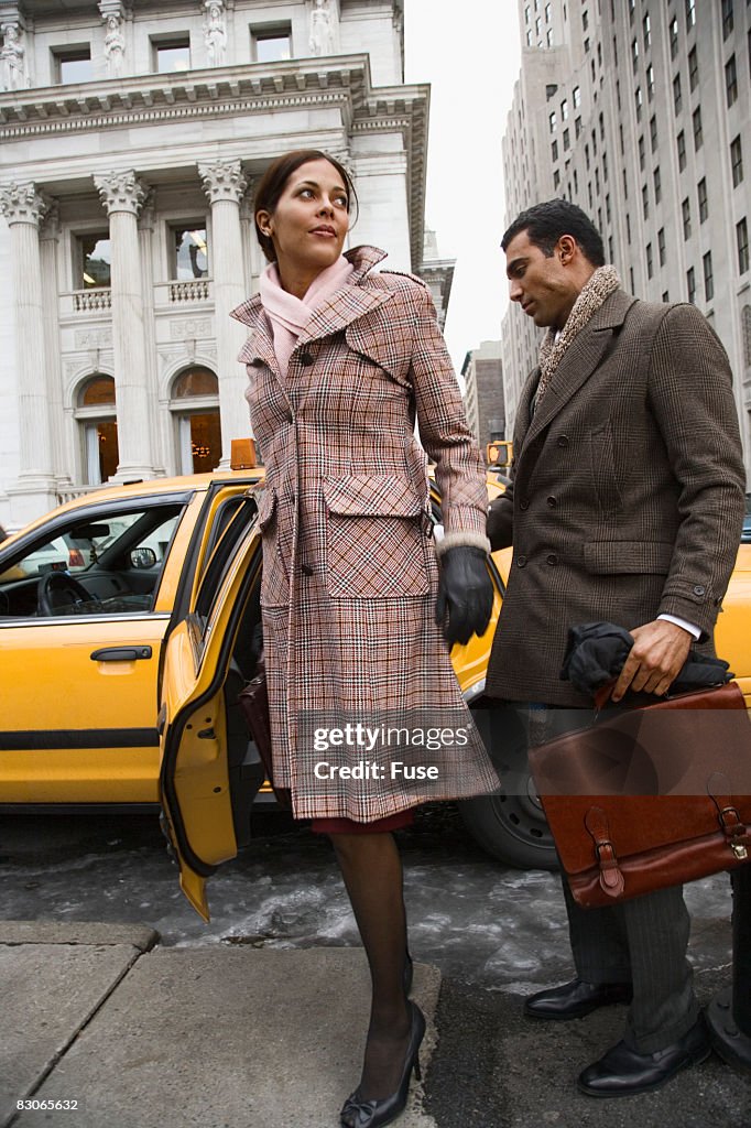 Businessman Checking Out Woman Getting Out of Taxi