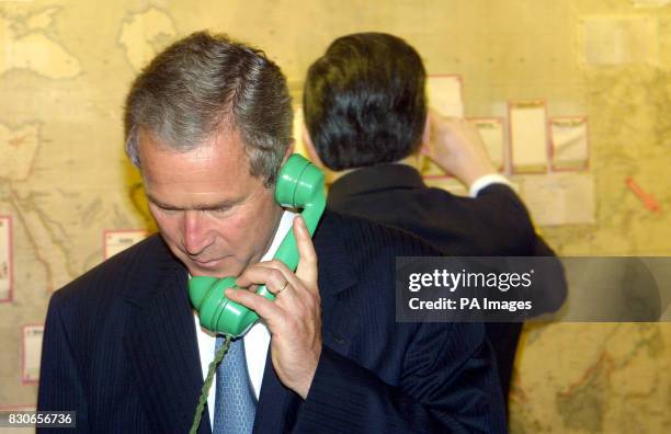 President George W. Bush tries a telephone in the map room of Winston Churchill's Cabinet War Rooms in London. The former The World War II leader's...