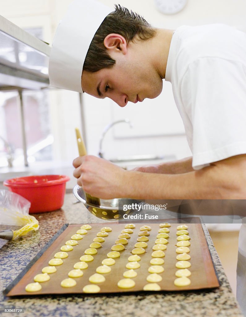 Baker Preparing Sheet of Cookies